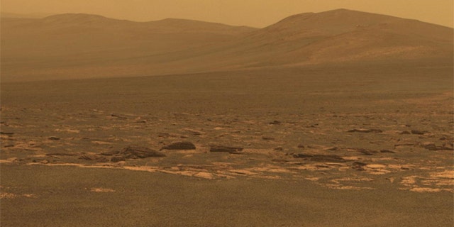 A portion of the west rim of Endeavour crater sweeps southward in this color view from NASA's Mars Exploration Rover Opportunity.