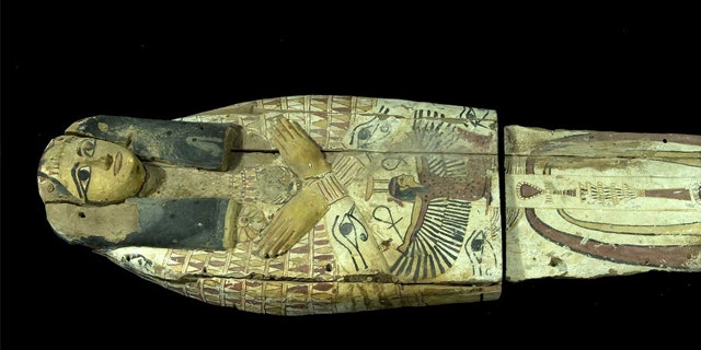 The wooden cover, which would have held a mummy in the past, had been cut in half, likely by smugglers who needed to fit the artifacts into a suitcase.