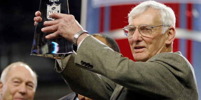 Dan Rooney, right, holding up the Vince Lombardi Trophy in 2006.