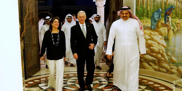 Qatar's Minister of Defence Khalid bin Mohammad Al-Attiyah (R) welcomes U.S. Defence Secretary James Mattis (C) and U.S. Ambassador to Qatar Dana Shell Smith (L) at his residence in Doha, Qatar April 22, 2017. REUTERS/Jonathan Ernst - RTS13GRB
