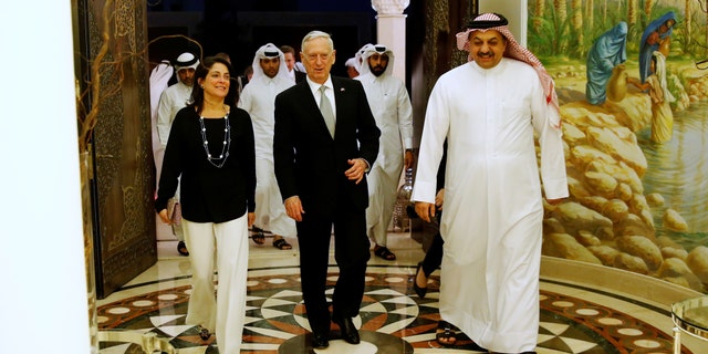 Qatar's Minister of Defence Khalid bin Mohammad Al-Attiyah (R) welcomes U.S. Defence Secretary James Mattis (C) and U.S. Ambassador to Qatar Dana Shell Smith (L) at his residence in Doha, Qatar April 22, 2017. REUTERS/Jonathan Ernst - RTS13GRB