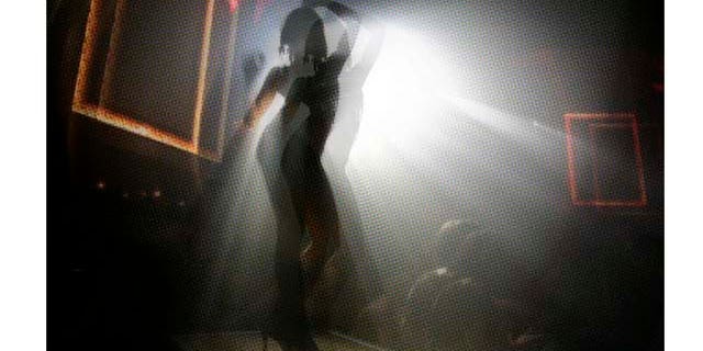 ** FOR IMMEDIATE RELEASE **A girl dances on a platform at the Mansion nightclub in Miami Beach, Fla., Nov. 10, 2006. (AP Photo/Lynne Sladky)