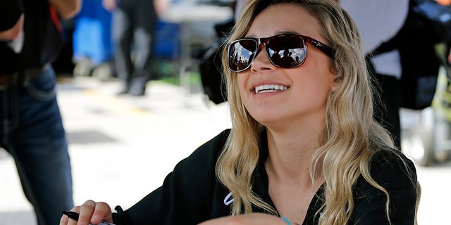 Natalie Decker signs autographs for fans before her ARCA race.