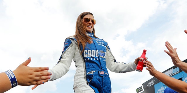 Danica Patrick greets fans before the NASCAR Cup Series auto race in Brooklyn, Mich., Sunday, Aug. 13, 2017. (AP Photo/Paul Sancya)