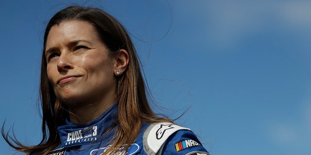 Danica Patrick stands near the garage area after practice for Sunday's NASCAR Cup series auto race, Saturday, July 29, 2017, in Long Pond, Pa. (AP Photo/Matt Slocum)