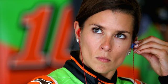 INDIANAPOLIS, IN - JULY 24: Danica Patrick, driver of the #10 GoDaddy Chevrolet, stands in the garage during practice for the NASCAR Sprint Cup Series Crown Royal Presents the Jeff Kyle 400 at the Brickyard at Indianapolis Motorspeedway on July 24, 2015 in Indianapolis, Indiana. (Photo by Sean Gardner/NASCAR via Getty Images)