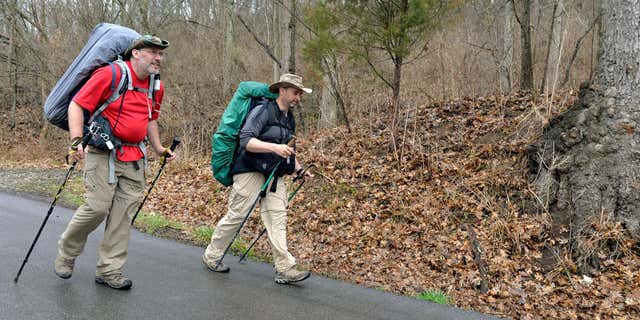 March 26, 2015: Curtis Penix, left and his walking partner Givan Fox walk Kentucky State Road 388 following the Boone Trace near Fort Boonesborough, Ky.