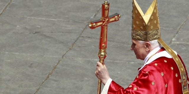 Pope Benedict XVI leaves at the end of the Palm Sunday mass at the Vatican April 17, 2011.