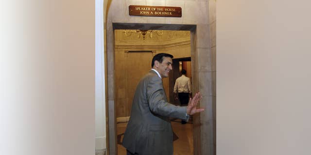 Rep. Darrell Issa, R-Calif., goes into Speaker John Boehner's office on Capitol Hill Friday, April 8, 2011 in Washington.(AP Photo/Alex Brandon)
