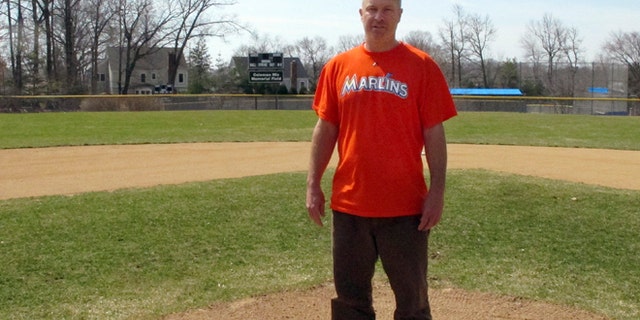 April 6, 2015: Christopher Stefanoni poses at the Darien Little League park in Darien, Conn. Stefanoni is suing the Darien Little League in federal court, saying league officials demoted his 9-year-old son to a lower-level team as retribution for his affordable housing proposal. Lawyers for the Little League deny the allegations.