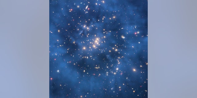 This Hubble Space Telescope composite image shows a ghostly "ring" of dark matter in the galaxy cluster Cl 0024+17.