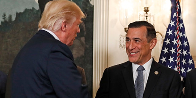 President Donald Trump, left, greets Rep. Darrell Issa, R-Calif., in the Diplomatic Reception Room of the White House in Washington, Monday, Aug. 14, 2017, before an event to sign a memorandum calling for a trade investigation of China. (AP Photo/Alex Brandon)