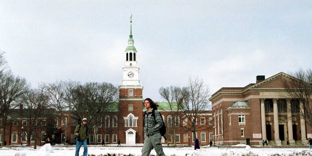A Dartmouth College student walks across the main campus. (Photo by Darren McCollester/Newsmakers)
