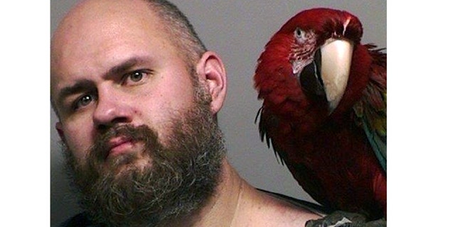 Mug shot for Craig Buckner and his macaw, "Bird."