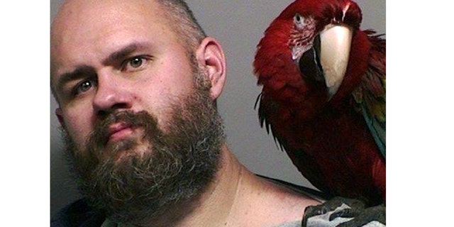 Mug shot for Craig Buckner and his macaw, "Bird."