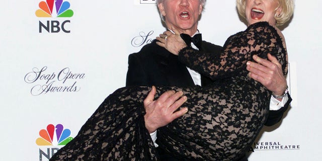 Actor David Canary holds Jennifer Bassey in his arms after they won the Favorite Couple award at the fifteenth annual Soap Opera Digest Awards, February 26 in Los Angeles. Canary plays Stuart and Bassey plays Marian on "All My Children." The awards show was broadcast live on the NBC television network.FSP/HB - RTRMC1F