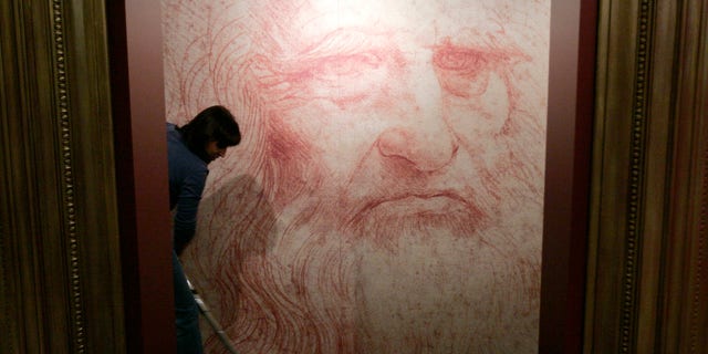 File photo - A cleaner vacuums in front of a Leonardo da Vinci self-portrait drawn around 1515 or 1516, during the inauguration of the exhibition "Leonardo da Vinci, the European Genius" in Brussels, August 17, 2007.