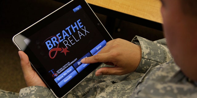 Sgt. Mark Miranda demonstrates the use of a new app that is designed to help calm symptoms of post-traumatic stress and traumatic brain injury.