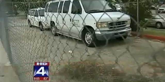 Vans outside Little T's Tiny Tots day care facility.