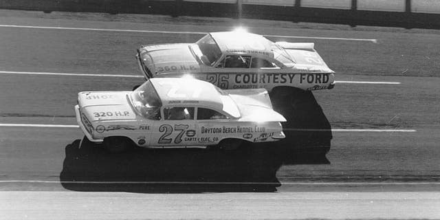 DAYTONA BEACH, FL - FEBRUARY 14: Eventual winner of the 1960 Daytona 500, Junior Johnson #27 ducks beneath Curtis Turner #26 who finished 7th during the Daytona 500 on February 14, 1960 at the Daytona International Speedway in Daytona Beach, Florida. There were so many wrecked and disabled cars following this event that NASCAR canceled the next two scheduled meets for fear of lack of participants. (Photo by ISC Archives via Getty Images)