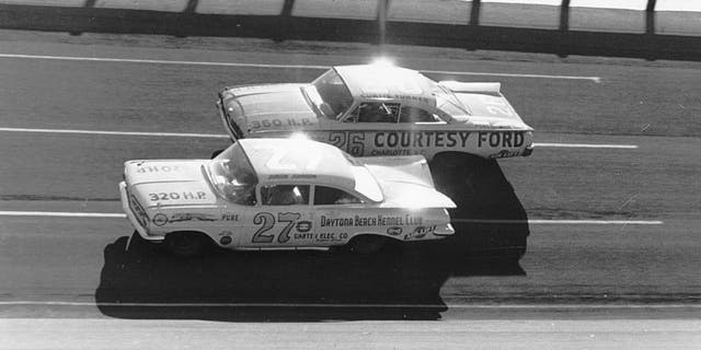 DAYTONA BEACH, FL - FEBRUARY 14: Eventual winner of the 1960 Daytona 500, Junior Johnson #27 ducks beneath Curtis Turner #26 who finished 7th during the Daytona 500 on February 14, 1960 at the Daytona International Speedway in Daytona Beach, Florida. There were so many wrecked and disabled cars following this event that NASCAR canceled the next two scheduled meets for fear of lack of participants. (Photo by ISC Archives via Getty Images)