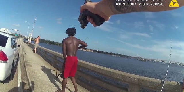 An officer pointed a gun at Goodin and demanded he surrender after he was witnessed throwing a man off a bridge into a river in Florida, according to police.