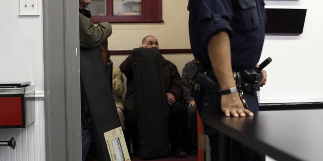 SAN FRANCISCO, CA - DECEMBER 15: People wait in line to turn in firearms during a gun buy back program on December 15, 2012 in San Francisco, California. The San Francisco police department held a one-day gun buy back event that paid $200 per gun turned in. A better than expected crowd resulted in payback money running out and vouchers were issued to collect money within a week. Over 200 guns were collected. (Photo by Justin Sullivan/Getty Images)