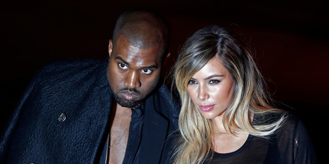 U.S. musician Kanye West and companion Kim Kardashian arrive at the Givenchy Spring/Summer 2014 women's ready-to-wear fashion show during Paris Fashion Week September 29, 2013