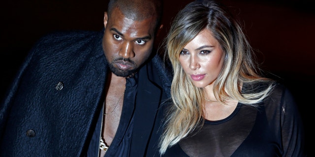 U.S. musician Kanye West and companion Kim Kardashian arrive at the Givenchy Spring/Summer 2014 women's ready-to-wear fashion show during Paris Fashion Week September 29, 2013