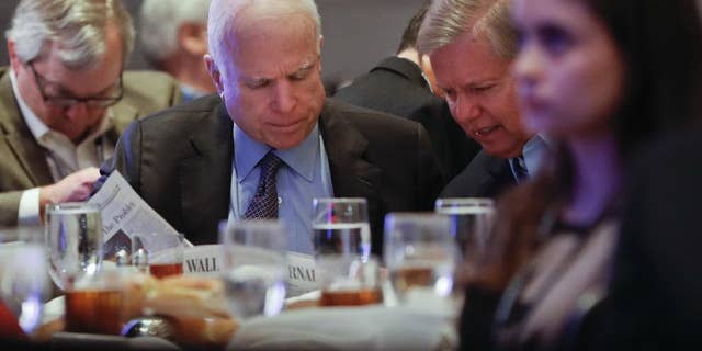 In this Jan. 26, 2017, photo, Sen. John McCain, R-Ariz., left, and Sen. Lindsey Graham, R-S.C., right, read the Wall Street Journal newspaper as they wait for President Donald Trump to speak at the House and Senate GOP lawmakers at the annual policy retreat in Philadelphia. McCain has emerged as Trump’s top Republican nemesis on Capitol Hill. Since Trump’s inauguration, McCain has broken with the president on his immigration order, warned him against any rapprochement with Moscow and lectured him on the illegality of torture. He supplied only a tepid endorsement of Rex Tillerson, Trump’s secretary of state nominee. (AP Photo/Pablo Martinez Monsivais)