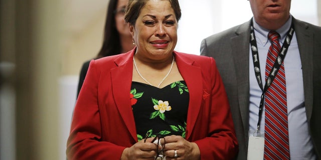 Chelan Lasha weeps as she returns to the courtroom after recess to testify against Bill Cosby during the comedian's sexual assault retrial