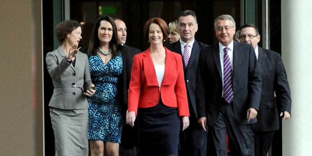 Feb. 27, 2012: Australian Prime Minister Julia Gillard, center, with supporters for the caucus meeting walks through the parliament house in Canberra, Australia.