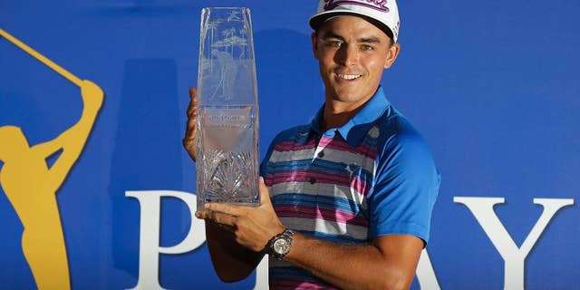Rickie Fowler holds The Players Championship trophy, Sunday, May 10, 2015, in Ponte Vedra Beach, Fla. Fowler won in a sudden death playoff against Kevin Kisner. (AP Photo/Chris O'Meara)