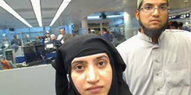 This July 27, 2014 photo provided by U.S. Customs and Border Protection shows Tashfeen Malik, left, and Syed Farook, as they passed through O'Hare International Airport in Chicago.