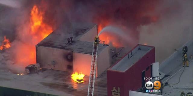 Firefighters battling the blaze on Monday.