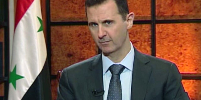 FILE - In this file image from video broadcast on Syrian state television Wednesday, April 17, 2013, President Bashar Assad speaks during an interview. The Syrian government wants more details before deciding whether to take part in a proposed U.S.-Russian initiative to negotiate a peaceful end to Syria's crisis, the country's information minister said Tuesday, May 14, 2013, staking out a similar position to the main opposition group. One of the key sticking points in even bringing the sides to the table for talks has been the role of Assad in any negotiated transition.(AP Photo/Syrian State TV via AP video, File)