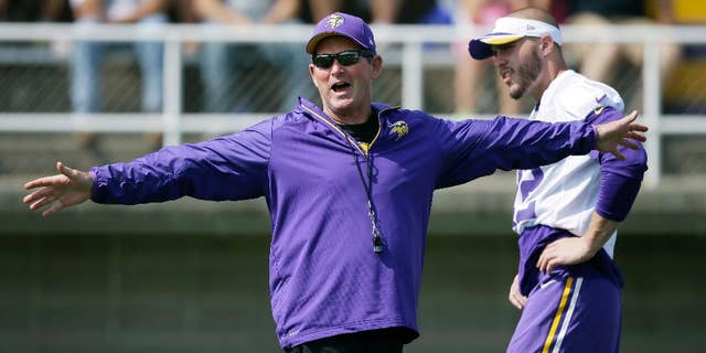 Minnesota Vikings head coach Mike Zimmer directs his team as free safety Harrison Smith, right, looks on during an NFL football training camp practice, Saturday, Aug. 2, 2014, in Mankato, Minn. (AP Photo/Charlie Neibergall)