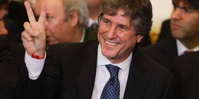 FILE- In this July 31, 2014, file photo, Argentina's Vice President Amado Boudou gestures to supporters before the speech of Argentine President Cristina Fernandez at Casa Rosada Presidential Palace in Buenos Aires, Argentina. Argentina's highest tribunal confirmed on Thursday, June 25, 2015, bribery charges against Boudou. If found guilty, the vice president could face prison and be barred for life from public office. (AP Photo/Victor R. Caivano, File)