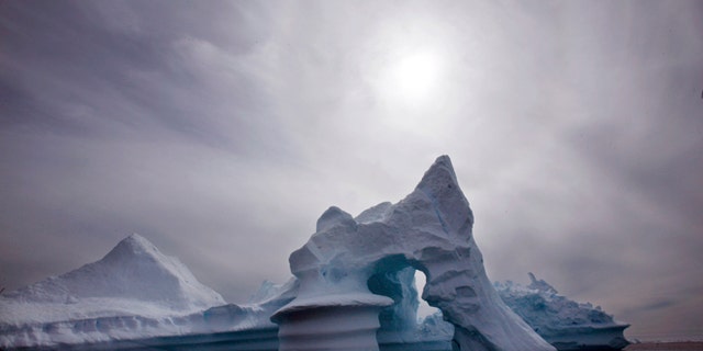 Scientists who are fine-tuning a landmark U.N. report on climate change are struggling to explain why global warming appears to have slowed down in the past 15 years even as greenhouse gas emissions keep rising.