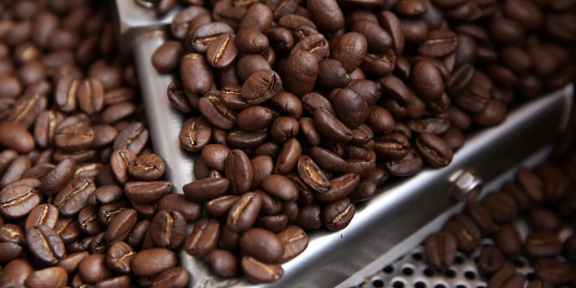FILE: Coffee beans are seen in a roaster.