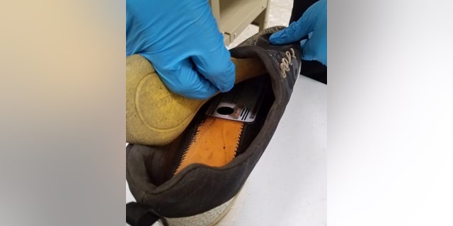 The man's real identification card was concealed in his shoe.