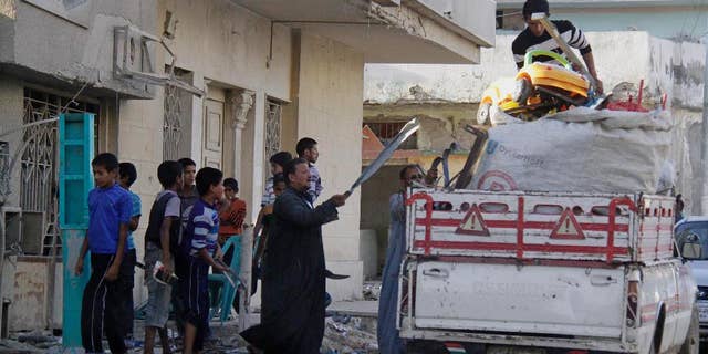 People collect their belongings from their residence as the Egyptian army demolish homes on the Egyptian side of border town of Rafah, northeast of Cairo, Egypt, Thursday, Nov. 6, 2014. In the deadliest-ever militant attack on the military, at least 30 soldiers were killed late last month in Sinai, prompting el-Sissi to declare a state of emergency in northern Sinai and order the eviction of some 10,000 people from the town of Rafah on the border with the Gaza Strip. (AP Photo/El Shorouk newspaper, Ahmed Abd El-Latif) EGYPT OUT