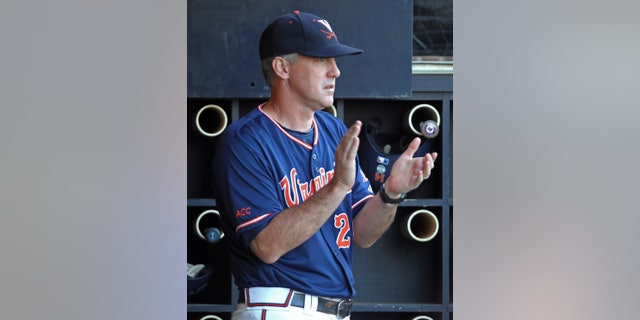 FILE - In this June 1, 2013, file photo, Virginia coach Brian O'Connor claps in the dugout during the fifth inning of an NCAA college baseball tournament regional game against Elon in Charlottesville, Va. O'Connor looked at his schedule, looked at how much talent was on his roster and knew he needed to make a change. A few phone calls later, O'Connor's Virginia baseball team no longer planned to open the season with a non-descript three-game series at home, but in a tournament in Wilmington, N.C., with three other quality programs. (AP Photo/Andrew Shurtleff, File)
