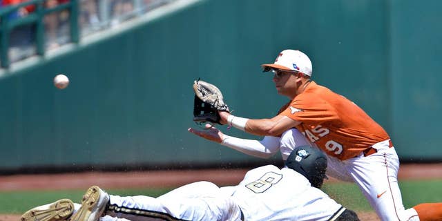 Vanderbilt's Rhett Wiseman (8) is caught stealing second base as Texas shortstop C.J Hinojosa (9) fields the throw in time during the second inning of an NCAA College World Series baseball game in Omaha, Neb., Friday, June 20, 2014. (AP Photo/Ted Kirk)