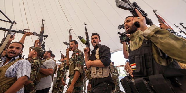 June 25, 2014: An Iraqi volunteer force chant slogans against the Al Qaeda-inspired Islamic State of Iraq and the Levant during training in the Shiite holy city of Karbala, 50 miles south of Baghdad. (AP Photo/Ahmed al-Husseini)