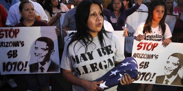 Demonstrators march to Arizona's State Capitol to protest the state's immigration law in Phoenix May 5. (Reuters Photo)