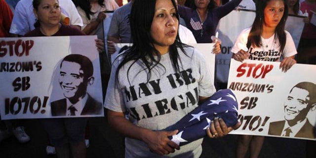 Demonstrators march to Arizona's State Capitol to protest the state's immigration law in Phoenix May 5. (Reuters Photo)