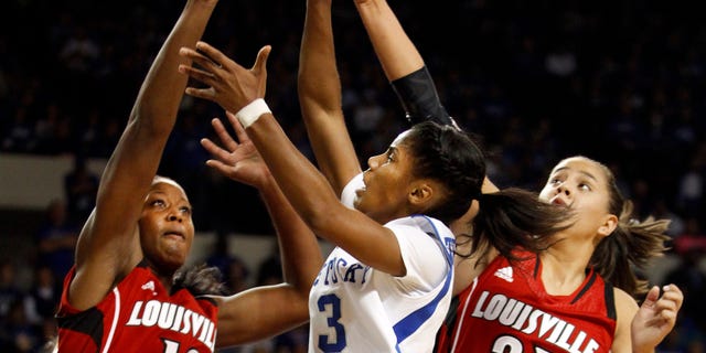Kentucky's Janee Thompson (3) shoots between Louisville's Shawnta' Dyer (12) and Shoni Schimmel (23) during the first half of an NCAA college basketball game on Sunday, Dec. 1, 2013, in Lexington, Ky. (AP Photo/James Crisp)