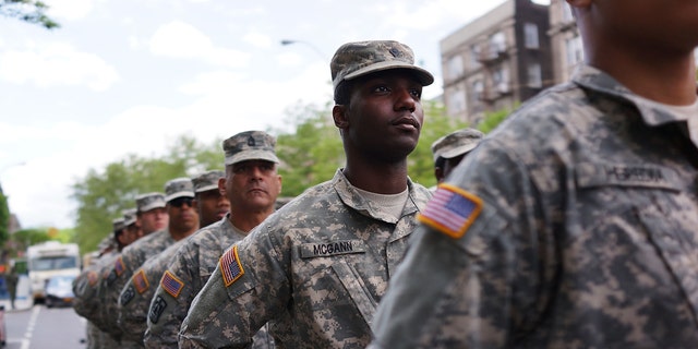 NEW YORK, NY - MAY 18:  Memebrs of the Army's 369th Infantry Regiment prepare to march with fellow soldiers, boy scouts and various other military aligned groups in the 369th Infantry Regiment Parade in Harlem on May 18, 2014 in New York City. The parade, which takes place on the historic Adam Clayton Powell Jr. Boulevard, looks to celebrate the contribution African Americans and Puerto Ricans have made to military. The 369th was home to the "Harlem Hellfighters", a unit made up of both African Americans and Puerto Ricans, which fought in both World War I and World War II.  (Photo by Spencer Platt/Getty Images)