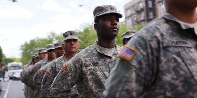 NEW YORK, NY - MAY 18: Memebrs of the Army's 369th Infantry Regiment prepare to march with fellow soldiers, boy scouts and various other military aligned groups in the 369th Infantry Regiment Parade in Harlem on May 18, 2014 in New York City. The parade, which takes place on the historic Adam Clayton Powell Jr. Boulevard, looks to celebrate the contribution African Americans and Puerto Ricans have made to military. The 369th was home to the "Harlem Hellfighters", a unit made up of both African Americans and Puerto Ricans, which fought in both World War I and World War II. (Photo by Spencer Platt/Getty Images)